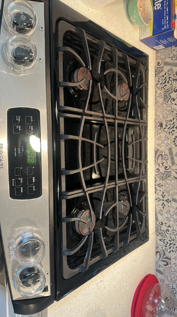AFTER: Same gas stove cooktop degreased and polished clean