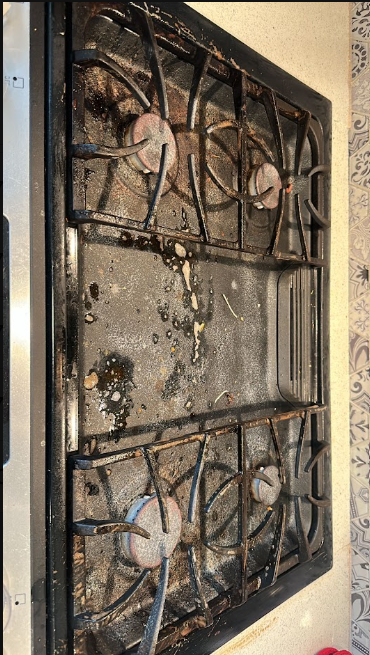 BEFORE: Gas stove cooktop with grease and food residue before cleaning